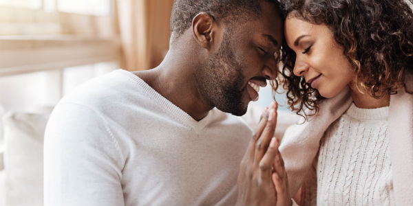 young couple holding hands face to face - Financial Finesse