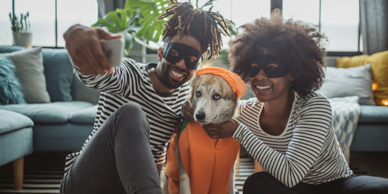 Couple with dog Halloween costumes - Financial Finesse